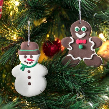 Homemade Model Magic snowman and gingerbread person ornaments hanging on tree