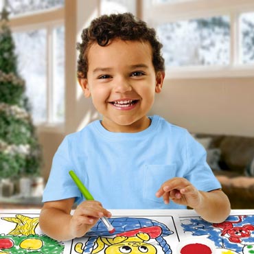 Toddler holding paintbrush and painting on a variety of animal coloring pages