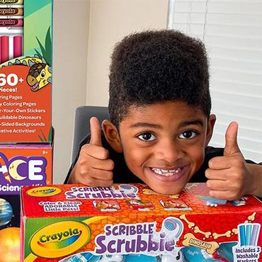 Kid with Crayola Scribble Scrubbie Playset and STEAM Kit giving thumbs up