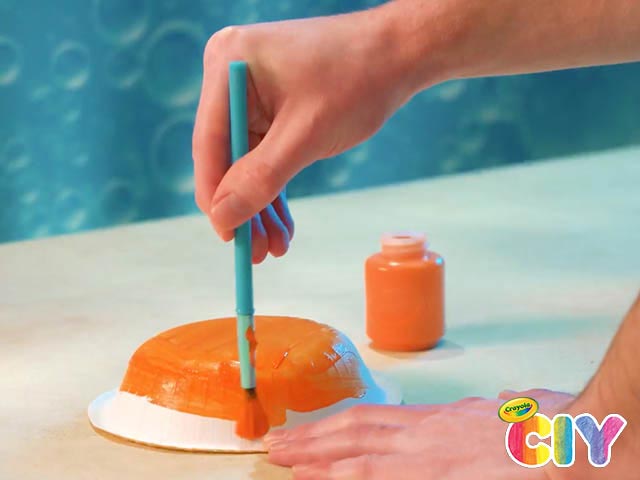 hand painting paper bowl orange with Crayola paint