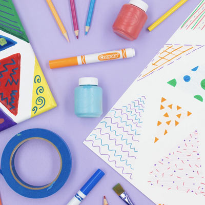 Canvas and paper with designs made with Crayola Paint, Markers, and more